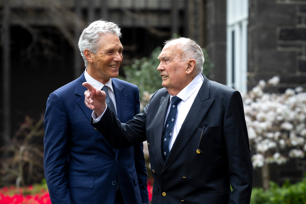 Two men outside school building